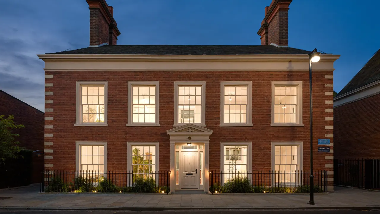 Cream painted sash windows on a traditional period home frontage